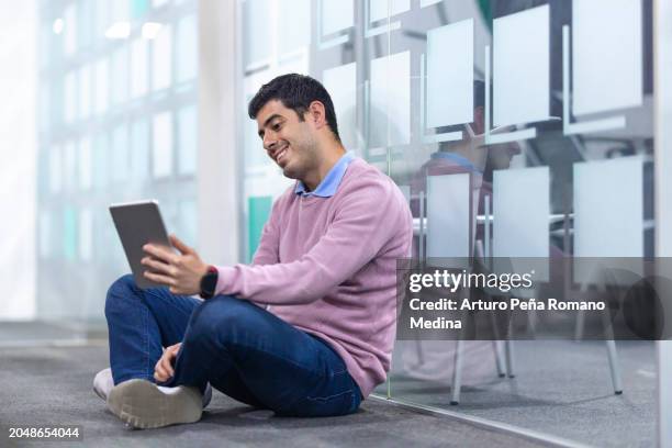young man taking a break on the floor - neurodiversity stock pictures, royalty-free photos & images