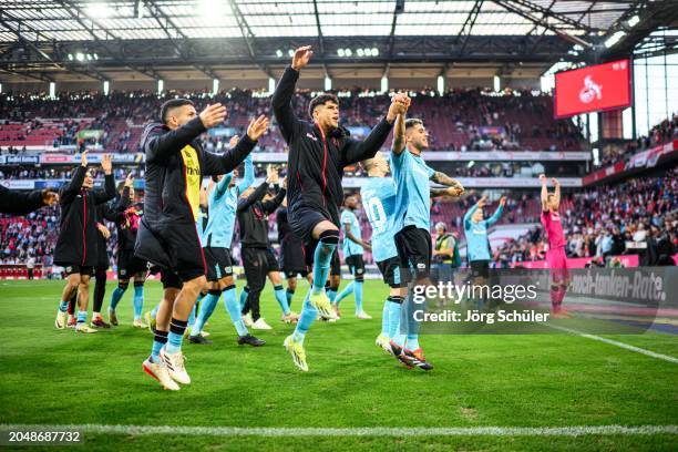 Gustavo Puerta, Piero Hincapie and Exequiel Palacios of Leverkusen celebrate their win with the fans after the Bundesliga match between 1. FC Köln...