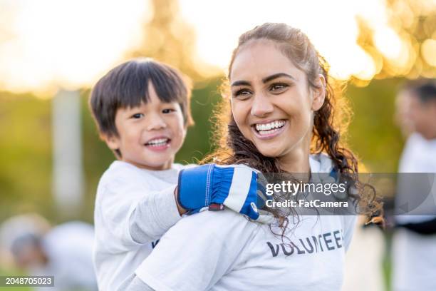 volunteering is fun! - wohltätigkeit und humanitäre hilfe stock-fotos und bilder