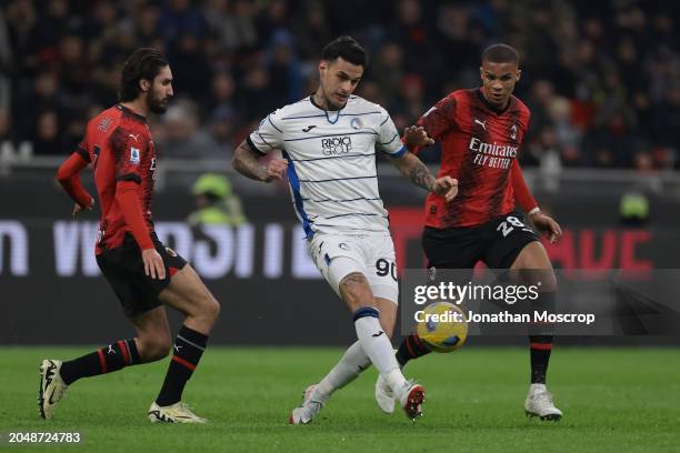 Gianluca Scamacca of Atalanta passes the ball as Yacine Adli and Malick Thiaw of AC Milan close in during the Serie A TIM match between AC Milan and...