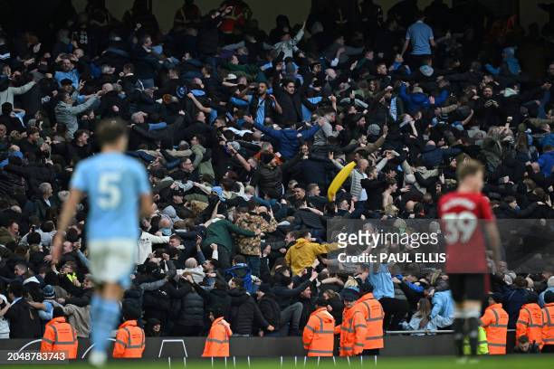City fans celebrate their third goal by doing their Poznan celebration during the English Premier League football match between Manchester City and...