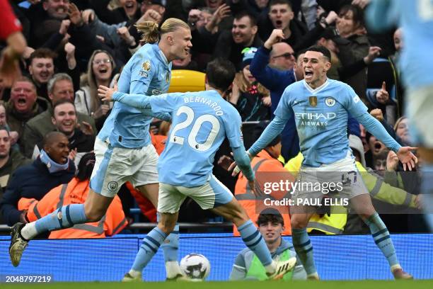 Manchester City's Norwegian striker Erling Haaland celebrates with Manchester City's Portuguese midfielder Bernardo Silva and Manchester City's...