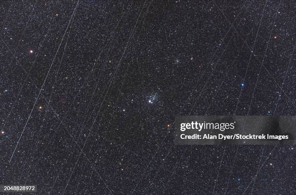 ngc 457, the owl cluster in cassiopeia, with accumulated satellite trails - space debris stock pictures, royalty-free photos & images