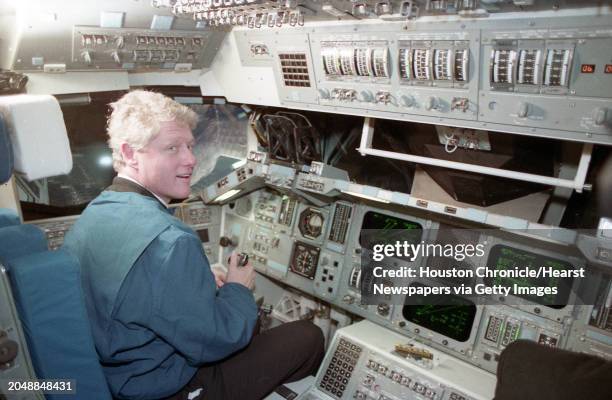 President Bill Clinton tries out the driver's seat of a space shuttle simulator trainer during a visit to the Johnson Space Center on Monday, Feb. 7,...