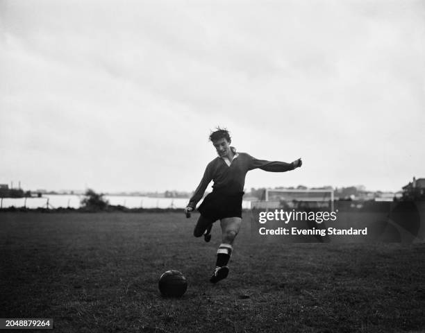 Chelsea Football Club winger Micky Block kicking a football during pre-season training, London, August 21st 1957.