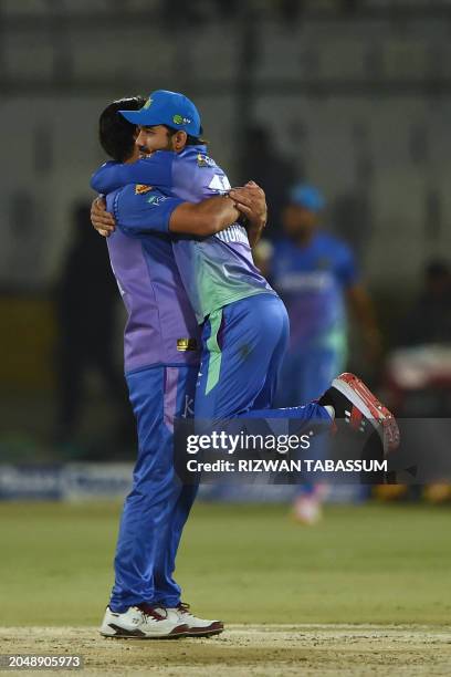 Multan Sultans' Mohammad Rizwan and Multan Sultans' Khushdil Shah celebrate after taking the wicket of Karachi Kings' Shoaib Malik during the...