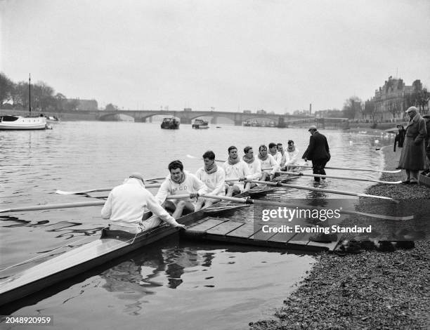 The Cambridge rowing crew sitting in their scull boat near Putney Bridge during the Boat Race, River Thames, London, March 24th 1956.