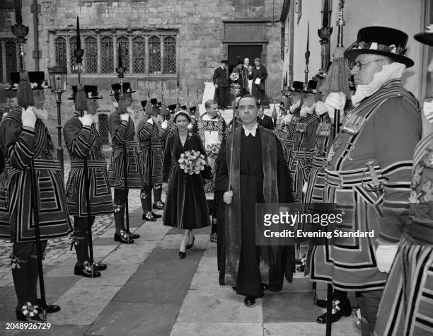 Queen Elizabeth II walks through a guard of honour formed of Beefeaters after distributing money at a Maundy Thursday service, London, March 29th...