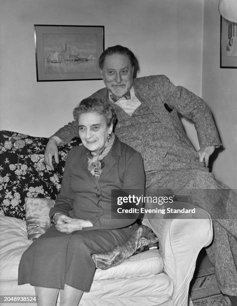 Authors Compton Mackenzie and wife, Faith Compton Mackenzie seated on a sofa, December 2nd 1955.