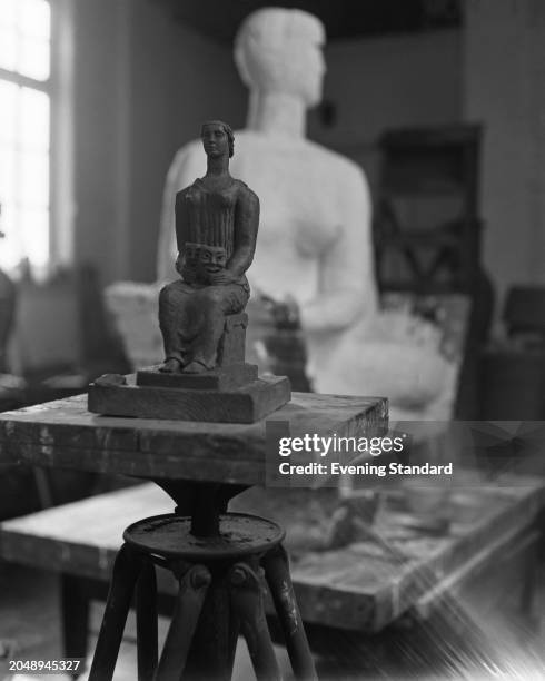 An Evening Standard Drama Award statuette designed by Frank Dobson on a pedestal in an artist's studio, November 23rd 1955.