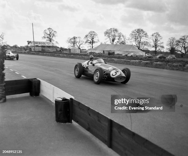 Racing driver Peter Collins driving a Maserati 250F during the BRDC International Trophy race, Silverstone circuit, Northamptonshire, May 7th 1955.