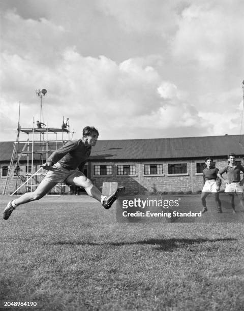 Romanian rugby union player Alexandre Penciu just after punting a ball while in training during a tour of England and Wales, September 28th 1955.