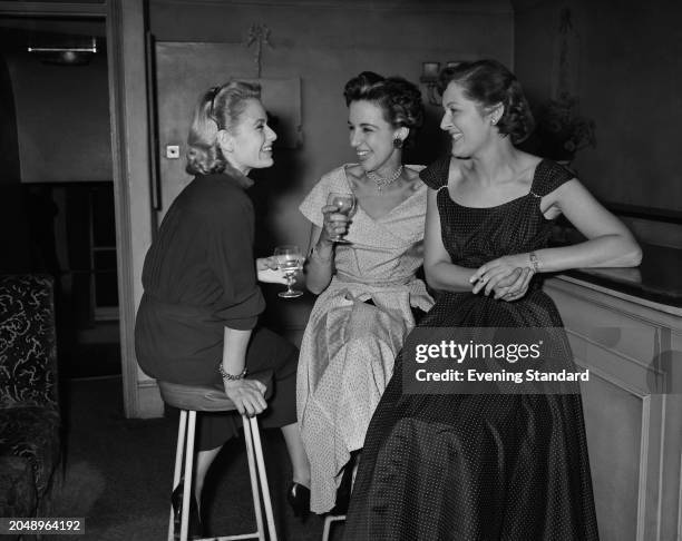 Actresses from left, Sally Bazely, Thelma Ruby and Billie Love smiling while holding drinks at a party, September 26th 1955.