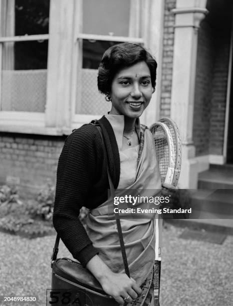 Indian tennis player Rita Davar holding her rackets, London, June 1955. Davar was competing in the first round of the Women's Singles tournament at...