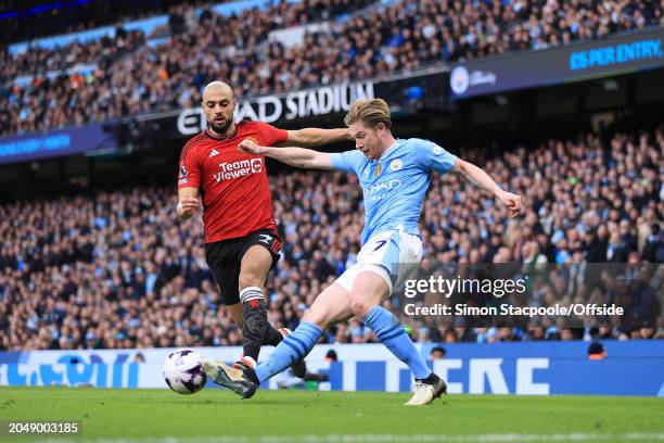 Kevin de Bruyne of Manchester City battles with Sofyan Amrabat of Manchester United during the Premier League match between Manchester City and...