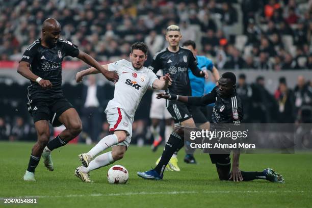 Dries Mertens of Galatasaray is challenged by Omar Colley and Al Musrati of Besiktas during the Turkish Super League match between Besiktas and...