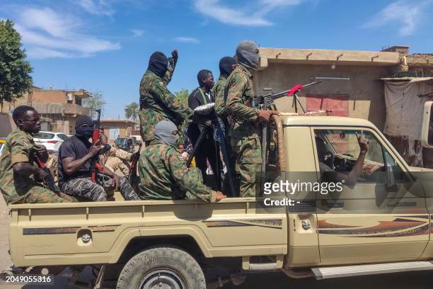 Supporters of the Sudanese armed popular resistance, which backs the army, ride on trucks in Gedaref in eastern Sudan on March 3 amid the ongoing...