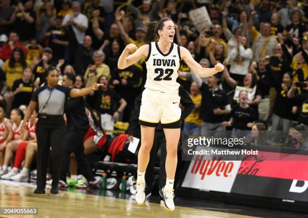 Guard Caitlin Clark of the Iowa Hawkeyes celebrates after breaking Pete Maravich's all-time NCAA scoring record during the first half against the...