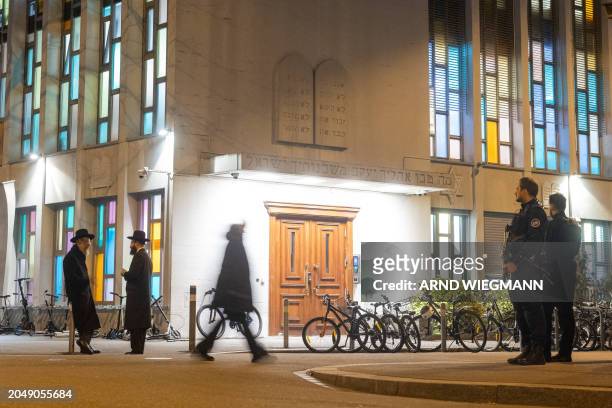 Police officers stand guard at the Synagoge Agudas Achim in Zurich, on March 3 after an Orthodox Jewish man was stabbed, late on March 2, 2024....