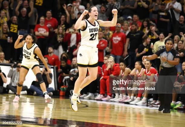 Guard Caitlin Clark of the Iowa Hawkeyes celebrates after breaking Pete Maravich's all-time NCAA scoring record during the first half against the...