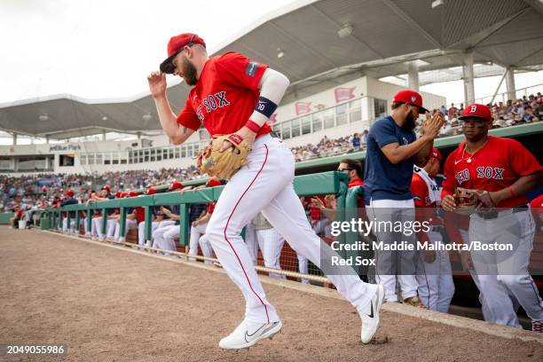 Trevor Story of the Boston Red Sox takes the field for the first inning of a Grapefruit League Spring Training game against the Toronto Blue Jays at...