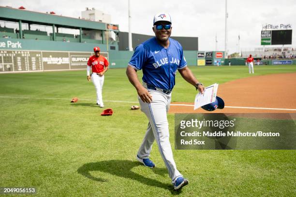 Former Boston Red Sox third base coach Carlos Febles reacts with Enmanuel Valdez of the Boston Red Sox before a Grapefruit League Spring Training...