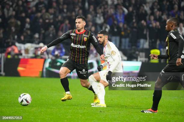 Ruben AGUILAR of Lens and Said BENRAHMA of Olympique Lyonnais during the Ligue 1 Uber Eats match between Lyon and Lens at Groupama Stadium on March...