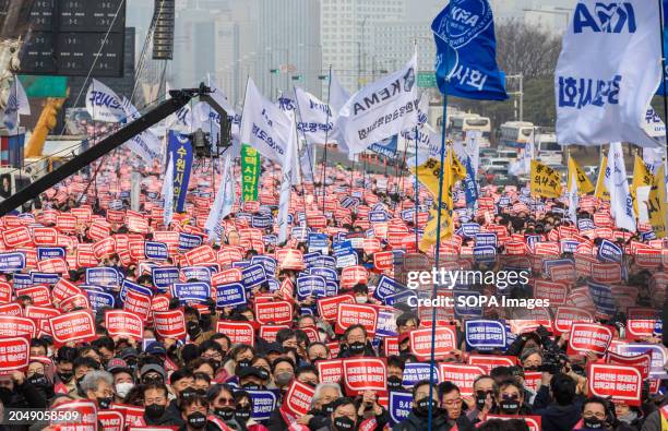 South Korean doctors hold placards saying "Opposition to the increase in medical schools" during the demonstration. Thousands of senior doctors held...