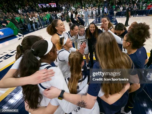 Notre Dame Fighting Irish guard Hannah Hidalgo celebrates with her teammates after a college basketball game between the Louisville Cardinals and the...