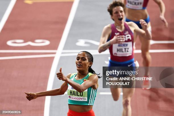 First-placed Ethiopia's Freweyni Hailu celebrates as she crosses the finish line to win the Women's 1500m final during the Indoor World Athletics...