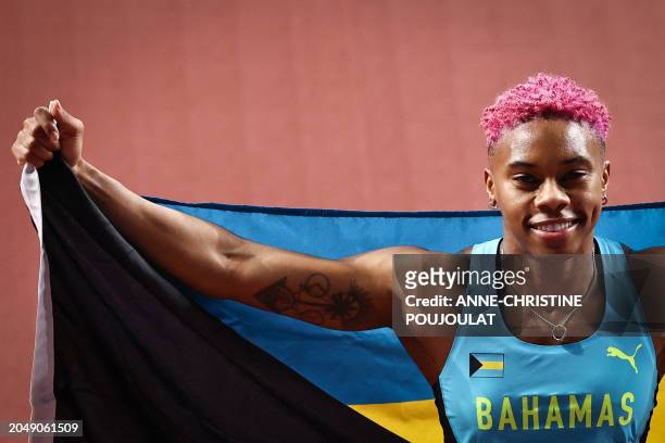 First-placed Bahamas' Charisma Taylor celebrates after winning in the Women's 60m hurdles final during the Indoor World Athletics Championships in...