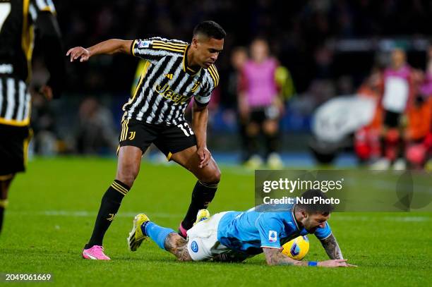 Alex Sandro of Juventus FC and Matteo Politano of SSC Napoli compete for the ball during the serie A TIM match between SSC Napoli and Juventus FC at...