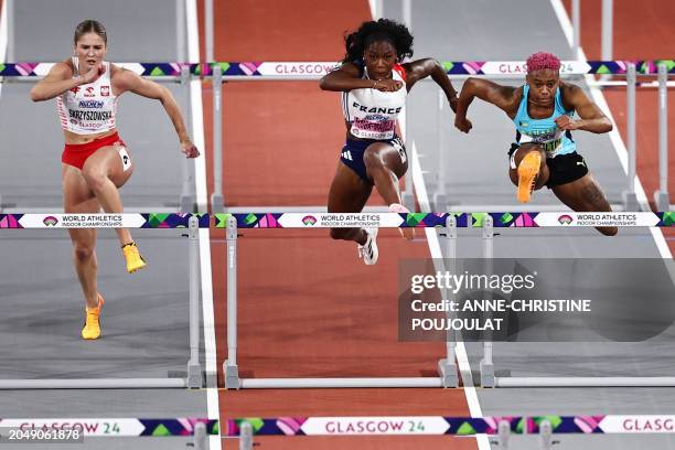 Poland's Pia Skrzyszowska, France's Cyrena Samba-Mayela and Bahamas' Devynne Charlton compete in the Women's 60m hurdles final during the Indoor...