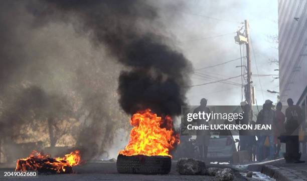 This screen grab taken from AFPTV shows tires on fire near the main prison of Port-au-Prince, Haiti, on March 3 after a breakout by several thousand...