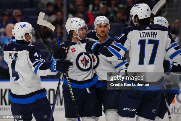Nino Niederreiter of the Winnipeg Jets celebrates with teammates after a goal during the first period of an NHL game against the Buffalo Sabres on...