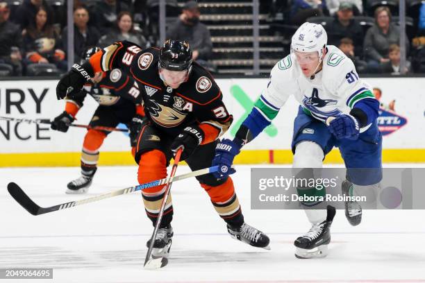 Jakob Silfverberg of the Anaheim Ducks and Nikita Zadorov of the Vancouver Canucks battle for the puck during the first period at Honda Center on...