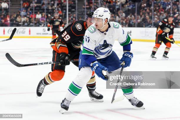 Sam Carrick of the Anaheim Ducks and Noah Juulsen of the Vancouver Canucks battle for position during the first period at Honda Center on March 3,...