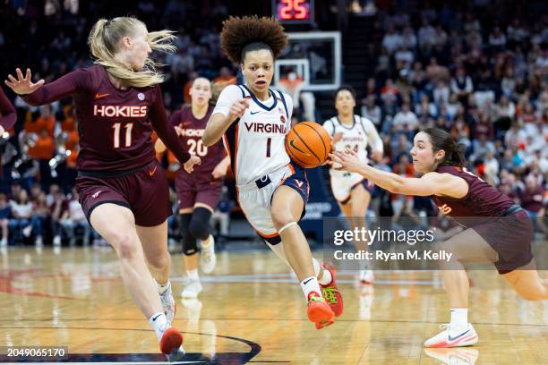 Paris Clark of the Virginia Cavaliers drives between Matilda Ekh and Georgia Amoore of the Virginia Tech Hokies in the second half at John Paul Jones...