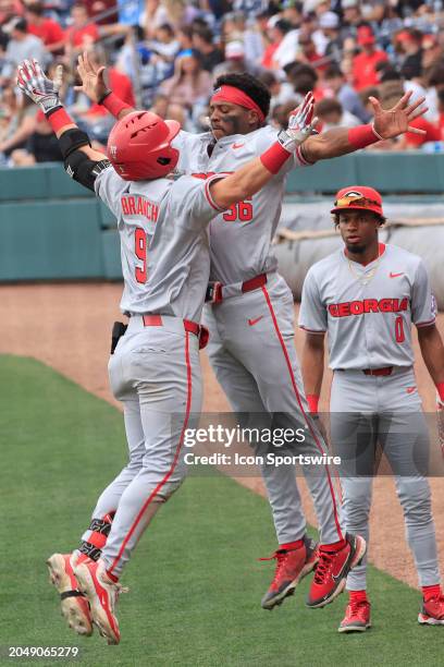 Georgia infielder Kolby Branch chest bumps Georgia outfielder Tre Phelps after hitting a home run during the men's college baseball game between the...