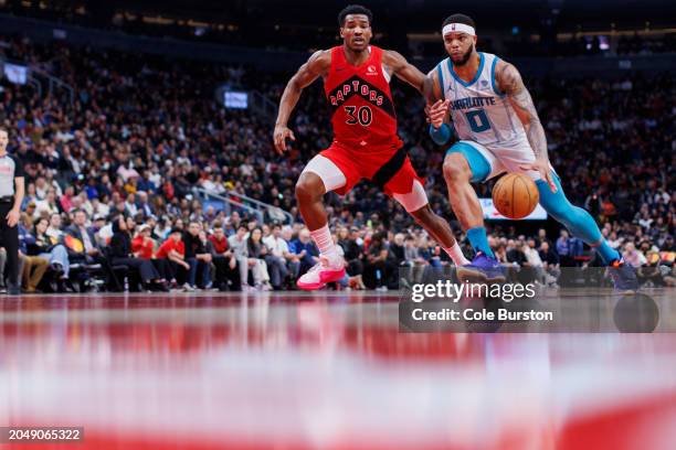 Miles Bridges of the Charlotte Hornets drives against Ochai Agbaji of the Toronto Raptors in the second half of their NBA game at Scotiabank Arena on...