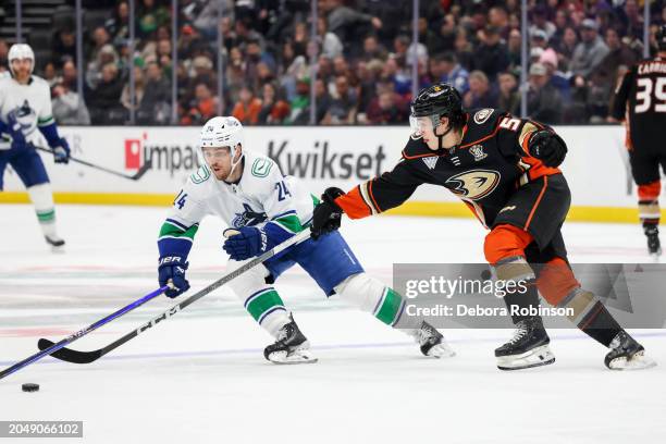 Pius Suter of the Vancouver Canucks and Olen Zellweger of the Anaheim Ducks battle for the puck during the second period at Honda Center on March 3,...