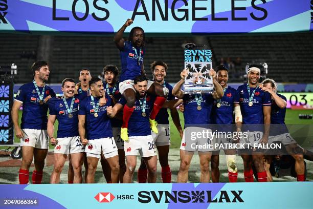 France's players celebrate with the trophy after winning the 2024 HSBC Rugby Sevens Los Angeles tournament final men's match against Great Britain at...