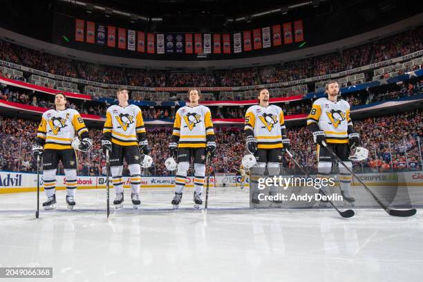 Sidney Crosby, Drew O'Connor, Rickard Rakell, Erik Karlsson and Marcus Pettersson of the Pittsburgh Penguins stand for the playing of the national...