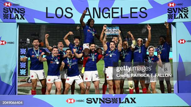 France's players celebrate with the trophy after winning the 2024 HSBC Rugby Sevens Los Angeles tournament final men's match against Great Britain at...