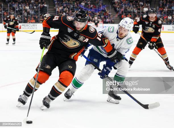Adam Henrique of the Anaheim Ducks and Pius Suter of the Vancouver Canucks battle for the puck during the third period at Honda Center on March 3,...