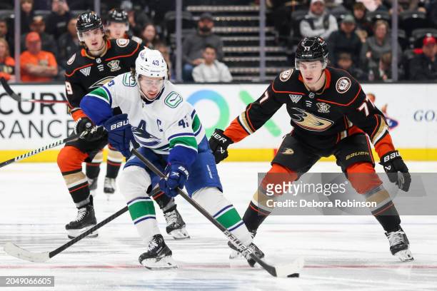 Quinn Hughes of the Vancouver Canucks and Frank Vatrano of the Anaheim Ducks battle for the puck during the third period at Honda Center on March 3,...