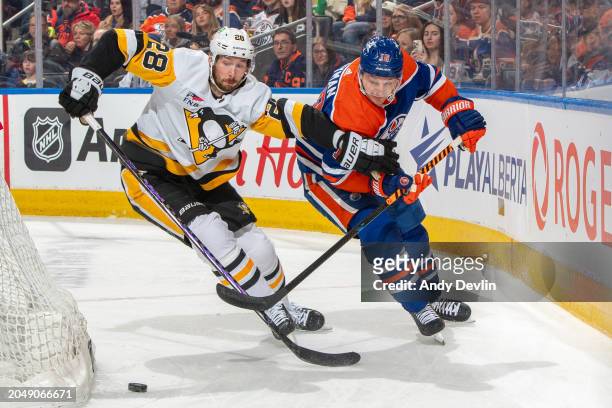 Zach Hyman of the Edmonton Oilers and Marcus Pettersson of the Pittsburgh Penguins battle for the puck during the game at Rogers Place on March 03 in...