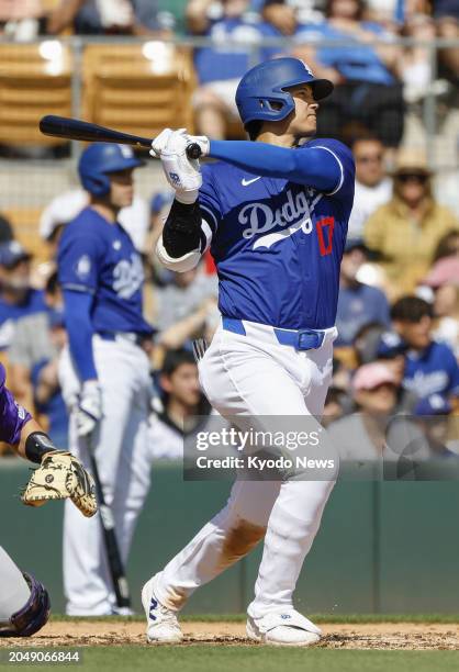 Shohei Ohtani of the Los Angeles Dodgers hits an RBI triple in the second inning of a spring training game against the Colorado Rockies in Glendale,...