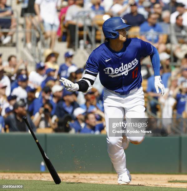 Shohei Ohtani of the Los Angeles Dodgers hits an RBI triple in the second inning of a spring training game against the Colorado Rockies in Glendale,...