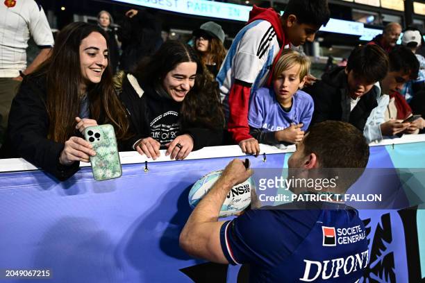 France's Antoine Dupont signs autographs for fans after France won the 2024 HSBC Rugby Sevens Los Angeles tournament final men's match against Great...
